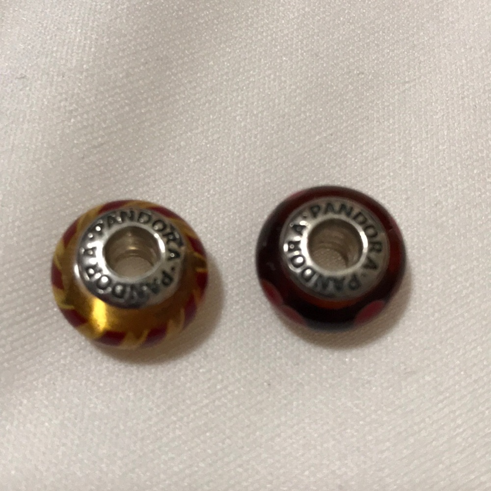 Two glass bead Pandora charms.